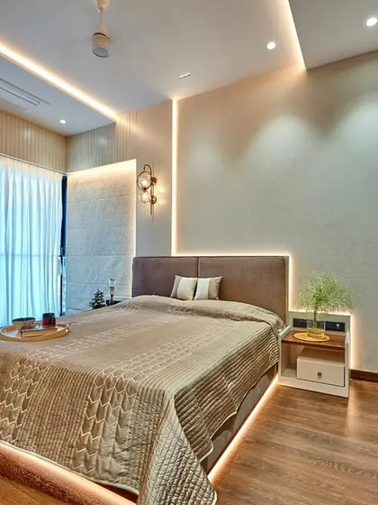Even a guest bedroom deserves a touch of luxury. We designed this room with warm wood floors, textured wall panels, and layered lighting, including a stylish designer wall lamp, to make guests feel truly welcome.