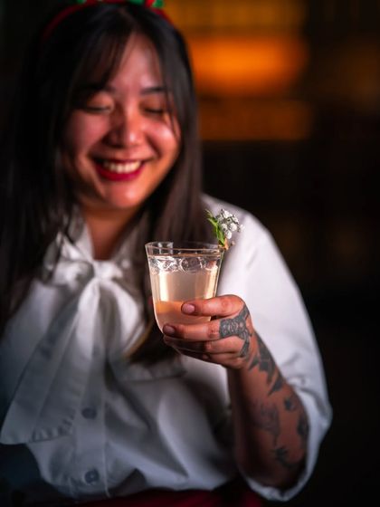 Serving up the holidays with a twist. A guest enjoys one of our festive cocktails, crafted with care and shaken with joy.