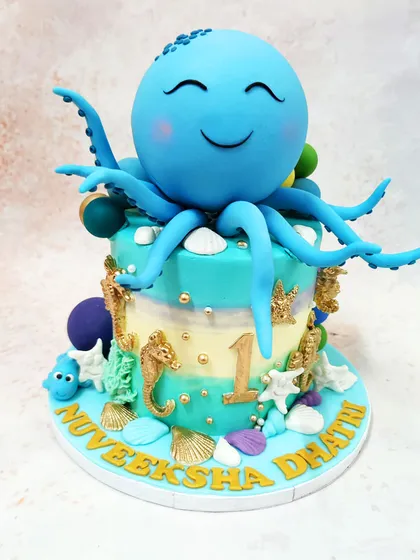 Our Blue Octopus Cake creates a full underwater scene, with the main character surrounded by golden seahorses, shells, and other sea life.