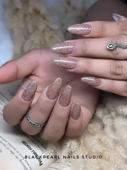 A full set of dazzling flash glitter nails. This type of glitter is highly reflective and creates an intense sparkle, especially under direct light or a camera flash.