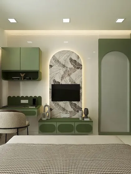 This bedroom was designed as a tranquil retreat, featuring a consistent sage green theme across the furniture. An arched niche with botanical wallpaper creates a beautiful backdrop for the TV, and a compact, scalloped desk provides a charming workspace by the window.