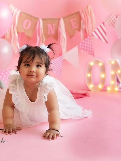 One of the twin girls exploring the set during her first birthday shoot. These crawling shots are a perfect way to remember this active and curious stage.