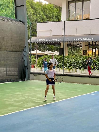 A young girl maintains her focus during a match at our academy. The ability to concentrate and reset after each point is a key mental skill we develop.