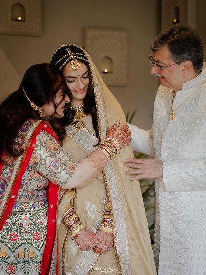 A beautiful, warm group hug between the bride and her parents. You can feel the love in this photo.