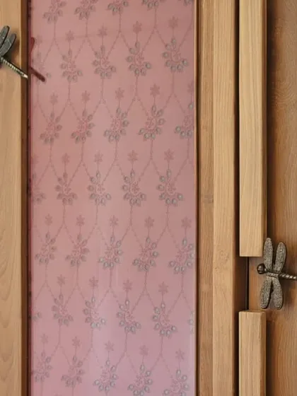 A close-up of a custom wardrobe, showcasing a blend of materials and artisanal details. The dragonfly handles, patterned fabric panel, and natural cane weave demonstrate my commitment to creating unique, tactile surfaces and celebrating fine craftsmanship in every piece.