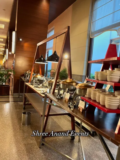A wide view of the indoor buffet line, showcasing the variety of dishes and the neat, professional presentation.