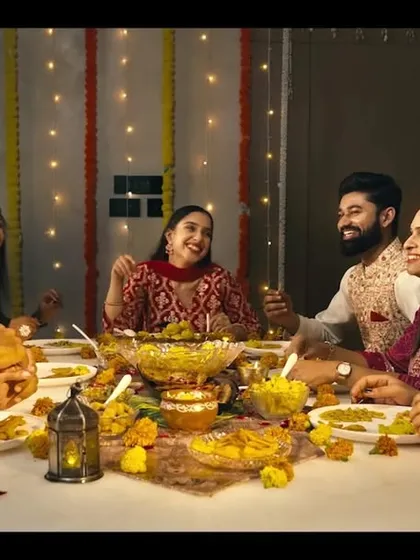 A festive dinner scene from the ad film, where all the cast members have coordinated, natural makeup that looks authentic and celebratory.