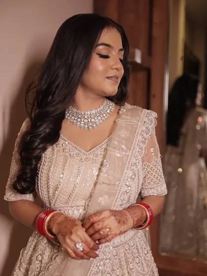 A close-up of the bride's reception look, showing the detail of her sequined lehenga and diamond jewelry.