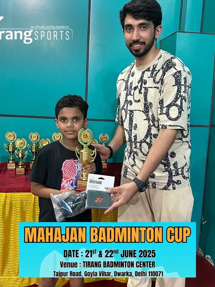 A young boy proudly displays his trophy and prizes. I partner with brands to provide exciting rewards for the winners.