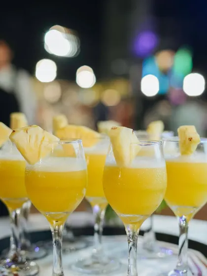A refreshing pineapple mocktail, perfect for a tropical-themed event. The fresh fruit garnish adds to the appeal.