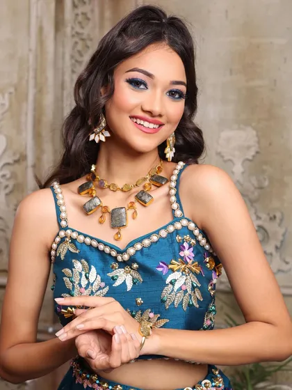 For this peppy and vibrant sangeet look, we went all out with color. Gorgeous blue eyes, flushed pink cheeks, and a creative hairdo make for a fun and festive style.