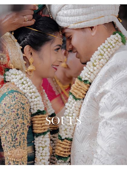 Two souls connecting amidst the sacred rituals. This image captures the quiet intimacy and shared look between the couple, a moment of peace during the wedding ceremony.