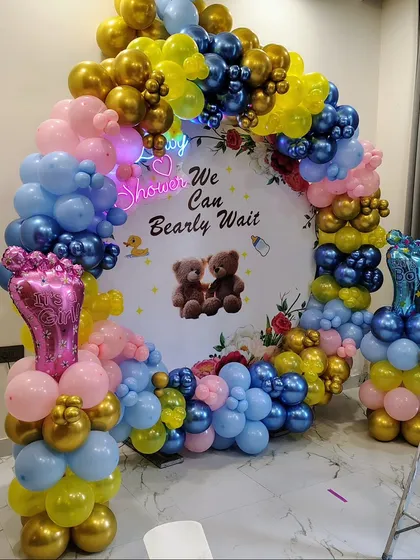 Another angle of the "Bearly Wait" baby shower, showing the cute baby foot foil balloons on columns.