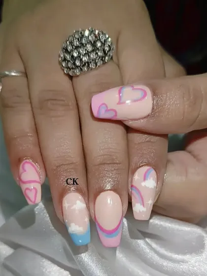 A close-up of the hand-painted hearts and clouds design.