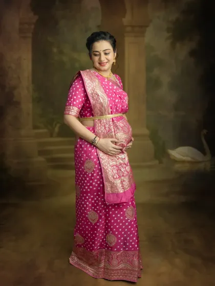 A simple and elegant portrait against a classic backdrop. The focus is entirely on you and the beautiful silhouette you create in this traditional saree.