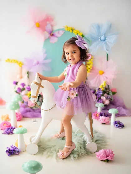 Let's bring your imagination to life! This whimsical fairy garden theme is a perfect example of the creative toddler photoshoots I love to design. With pastel colors, fun props like this rocking horse, and a touch of magic, we can create a fairytale world for your little one.