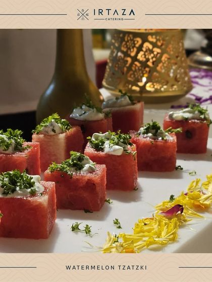 A refreshing and healthy appetizer of Watermelon Tzatziki. Cubes of fresh watermelon are topped with a creamy yogurt sauce and herbs.