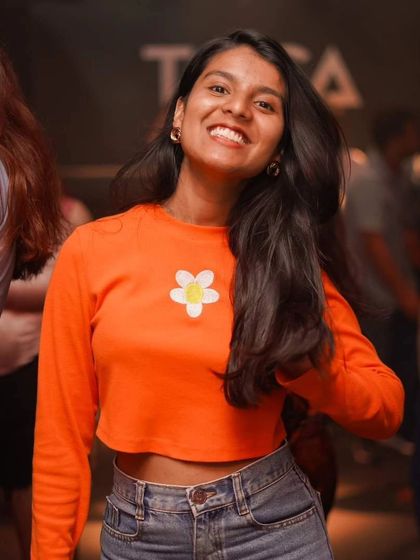 A bright smile and a cool outfit on the dancefloor at Toca Brigade. The crowd always brings their best style and energy.