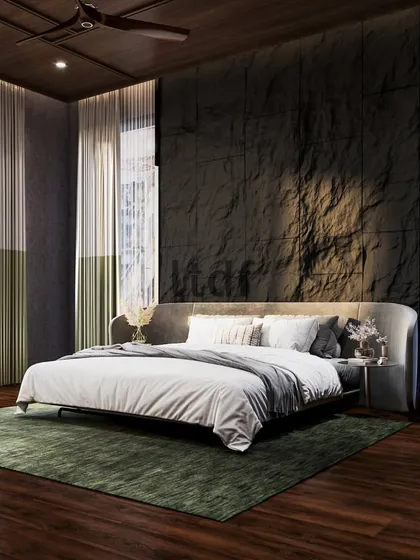 Surrounding yourself with natural elements fosters tranquility. This bedroom makes a powerful statement with a rocky, tactile feature wall, emulating strength and roughness. This is balanced by the comforting touch of wooden flooring and soft natural light from full-height windows.