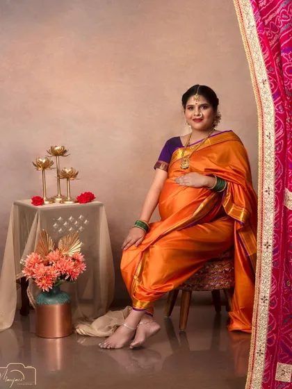 A beautiful portrait inspired by classic Indian paintings. The mama-to-be looks ethereal in an orange and purple saree.