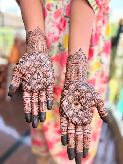 I love personalizing designs for my clients. Here, I've hidden the couple's initials 'B' and 'S' within a beautiful lotus jaal pattern. This style of intricate grid work filled with floral motifs is a classic choice for engagement and bridal mehendi.