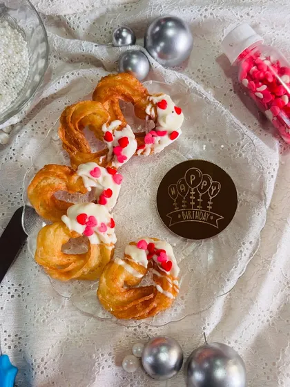 My heart-shaped churros are perfect for celebrations, as seen here on a platter ready for a birthday party. This setup shows how my treats can be the centerpiece of your dessert table, bringing a unique and sweet element to any event.