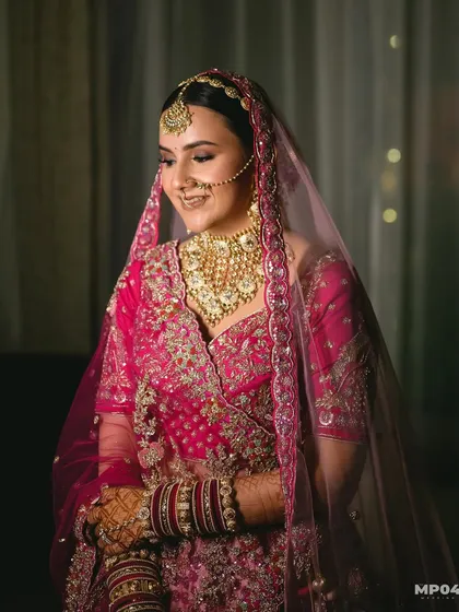 My beautiful bride Aayushii in her stunning pink wedding lehenga. The makeup was kept soft and glowing to complement her outfit, with a focus on defined eyes and a natural lip colour.