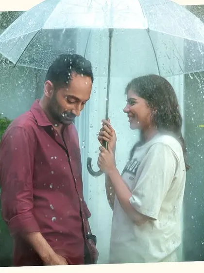 A beautiful, atmospheric shot from 'Odum Kuthira Chaadum Kuthira'. Even in challenging lighting like this rain sequence, the makeup must remain flawless and contribute to the scene's mood without looking artificial.