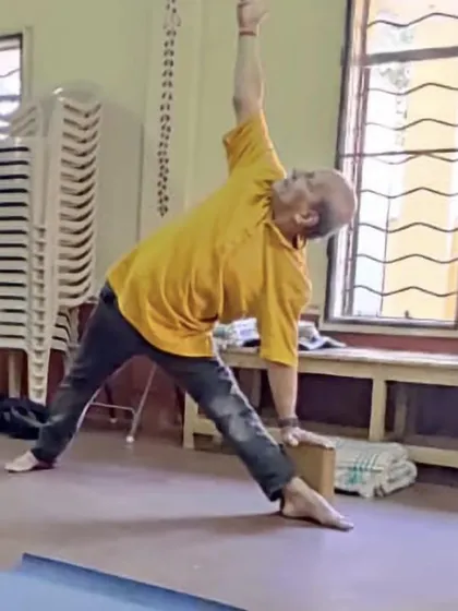 Trikonasana (Triangle Pose) with a block.