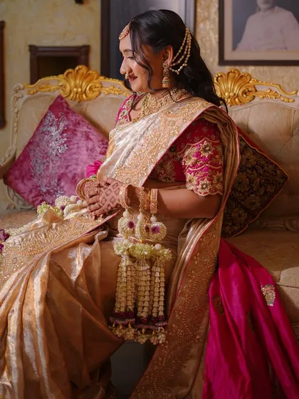 A side profile showing the intricate details of the floral jewellery and hairpiece.