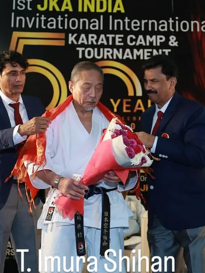 Showing respect to our masters is a cornerstone of karate tradition. This photo captures the honoring of T. Imura Shihan at a JKA India International Karate Camp, an event I was proud to be a part of.