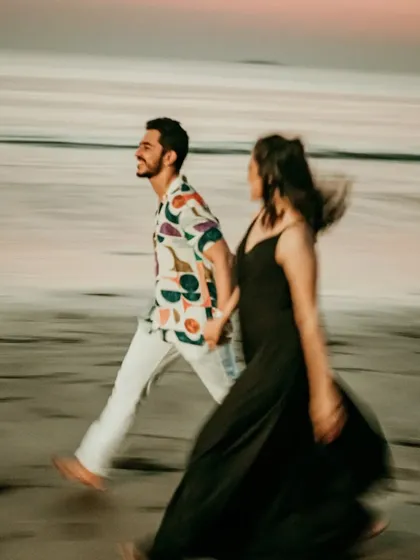 A candid, motion-blur shot of a couple walking along the beach. This artistic technique adds a dynamic and dreamy quality to the pre-wedding photograph.