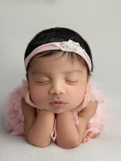 The 'chin on hands' pose with a sweet pouty lip expression. These fleeting moments are what I aim to capture in every session.