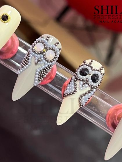 An incredibly detailed owl design created with tiny, hand-placed beads for a stunning mosaic effect.