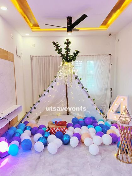 A close-up of the canopy tent from the home birthday setup, adorned with fairy lights and greenery, making it a perfect little hideaway for the celebration.