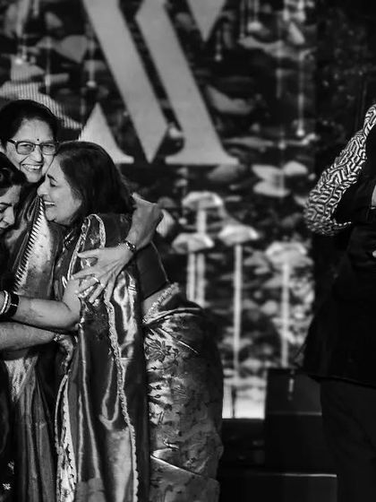 A heartwarming black and white photo of the families embracing after the ceremony. These moments of shared joy and connection are what make a wedding so special.