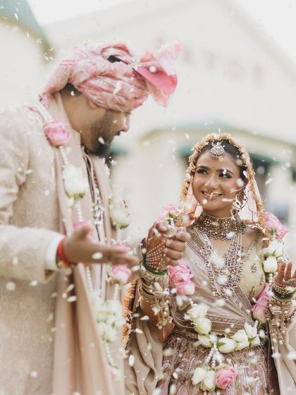 The happiness of the varmala ceremony. Vasav's makeup is fresh and luminous, perfect for a daytime wedding.