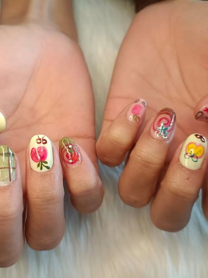 A recreation of an artist's work, this set features a variety of quirky, hand-painted designs on each nail, including plaid, fruits, and flowers.
