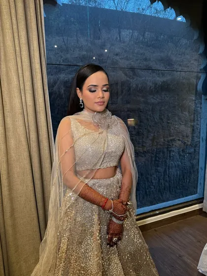A close-up of Shreya's Sangeet glam. The look features shimmering silver eyeshadow and a flawless base, creating a magical and ethereal vibe.