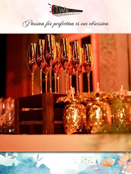 A display of elegant gold champagne flutes and pineapple-themed glasses at an event.