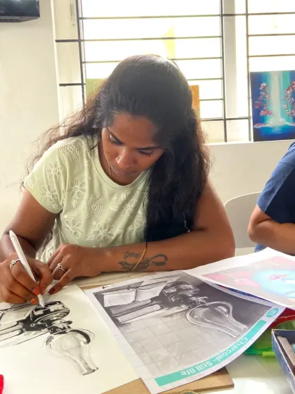 This student is learning charcoal drawing, a powerful medium for creating dramatic and expressive artworks.