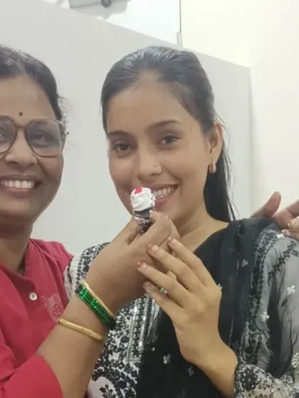Another heartwarming moment between a teacher and student, sharing cake and smiles on Teacher's Day.