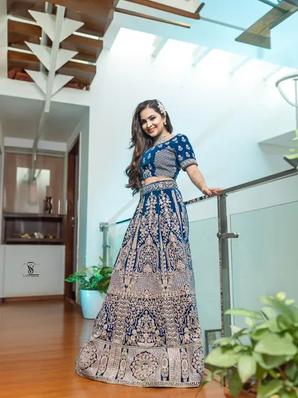 Make a grand statement with this peacock blue bridal lehenga. The detailed embroidery creates a rich, luxurious look that is perfect for a wedding reception or sangeet ceremony.