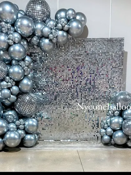 I brought the disco fever with this all-silver party theme. The centerpiece is a reflective silver sequin wall, framed by a chrome balloon arch that includes mini disco ball details for that extra sparkle.