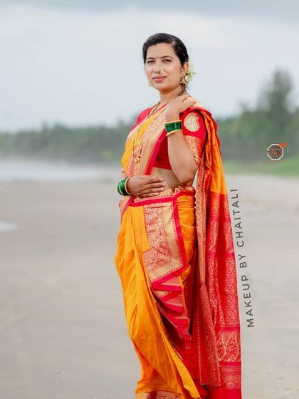 A full view of the client's traditional attire and makeup at the beach. The look is timeless and perfect for a cultural photoshoot or event.