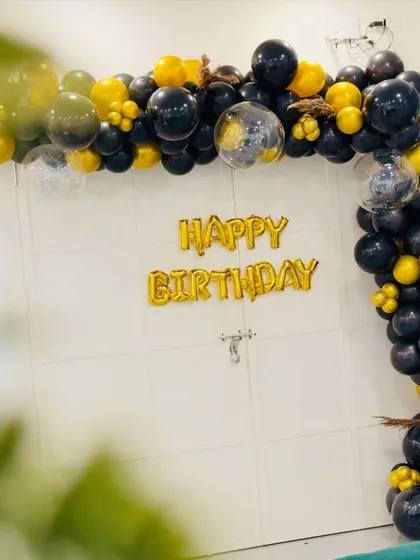 A wide shot showing how the black and gold balloon arch frames the party space. My decorations are designed to complement the venue and create a festive atmosphere.