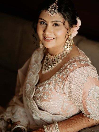 A happy and radiant bride. This close-up portrait captures her beautiful smile and the sparkle in her eyes, along with the stunning details of her jewelry.