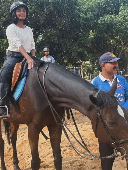 A student and I share a moment after a lesson. I am always close by to provide guidance and ensure our riders feel supported.