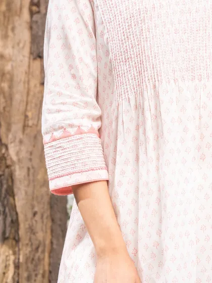 A detail of the sleeve cuff on a Suhani Appliqué top. The combination of pintucks and hand-stitched trims showcases the meticulous work that goes into each garment, making it truly special.