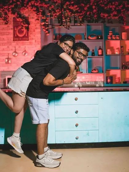 A playful piggyback ride in the kitchen, capturing a moment of pure fun.